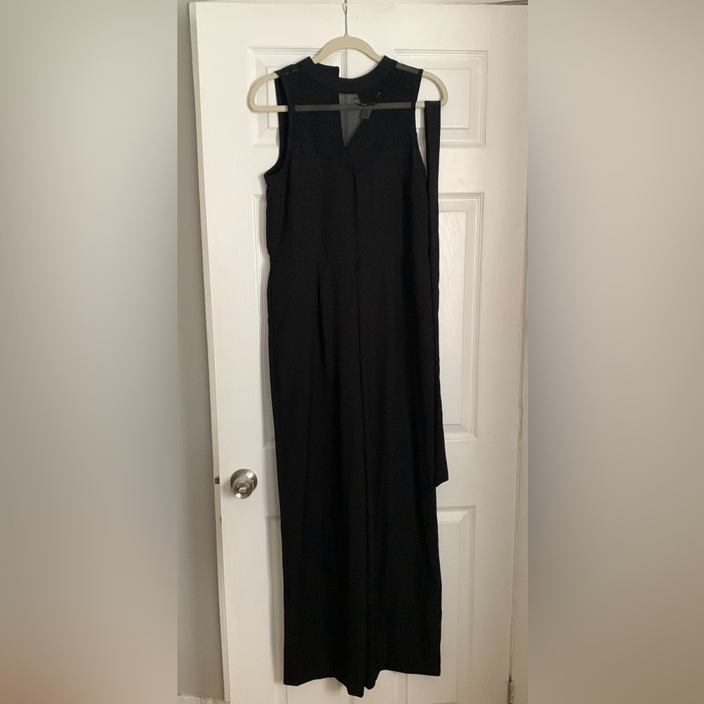 Black jumpsuit with sheer chest detail. Size 6. From tjmax